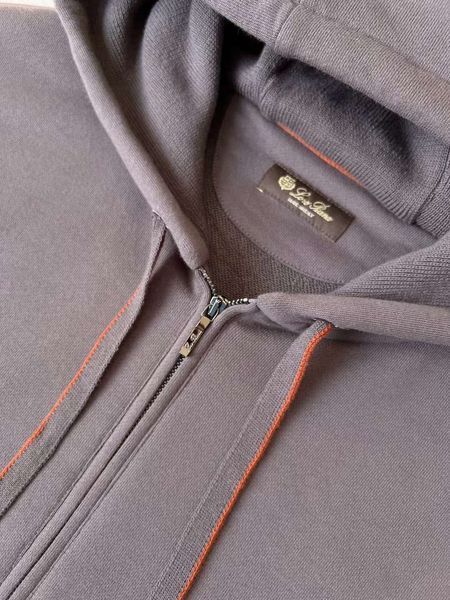 Men's suit with an elastic band on the cuff and a red ribbon