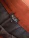 Men's suit with an elastic band on the cuff and a red ribbon
